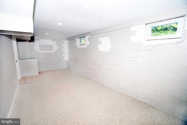 basement with light colored carpet and a wealth of natural light