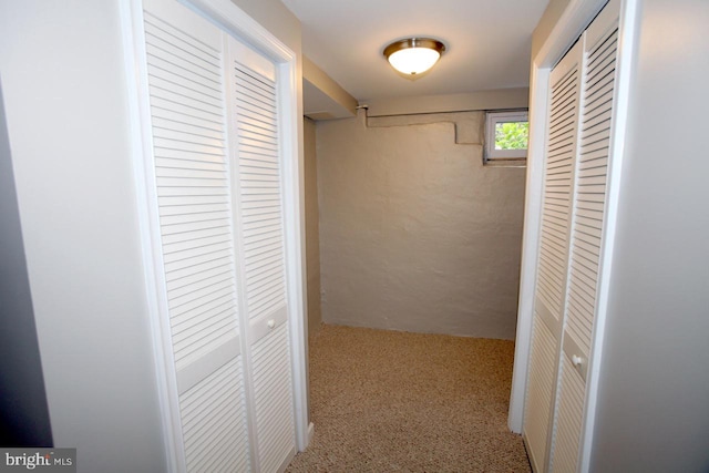 hall featuring carpet flooring