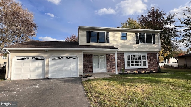 view of property with a garage and a front lawn