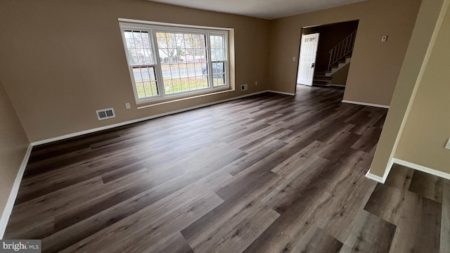 spare room with dark hardwood / wood-style flooring