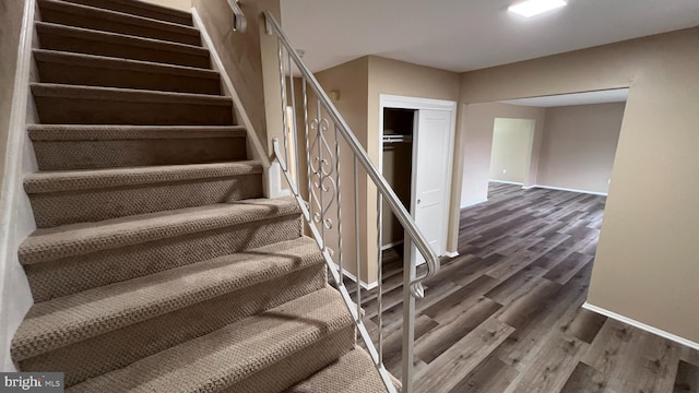 stairs featuring hardwood / wood-style flooring