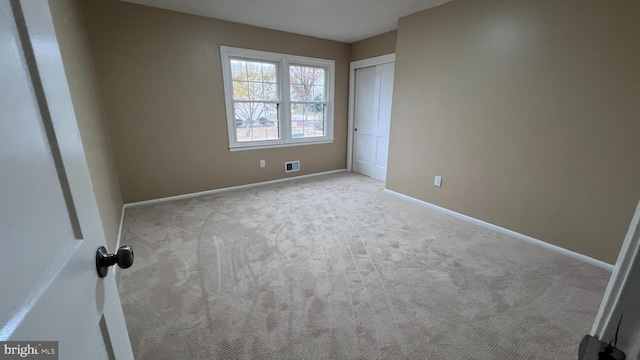 unfurnished bedroom with light carpet