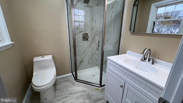 bathroom featuring an enclosed shower, vanity, and toilet