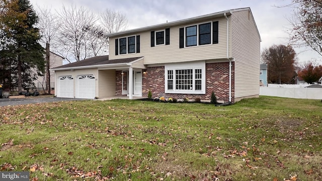 front facade with a front yard and a garage