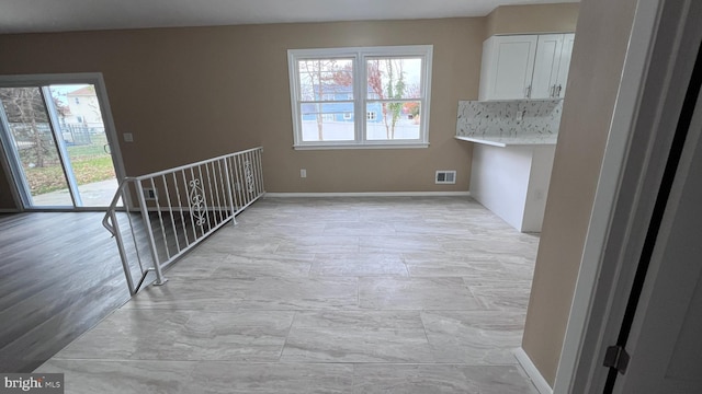 unfurnished dining area with light hardwood / wood-style floors