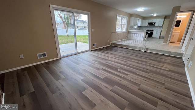 unfurnished living room with light wood-type flooring