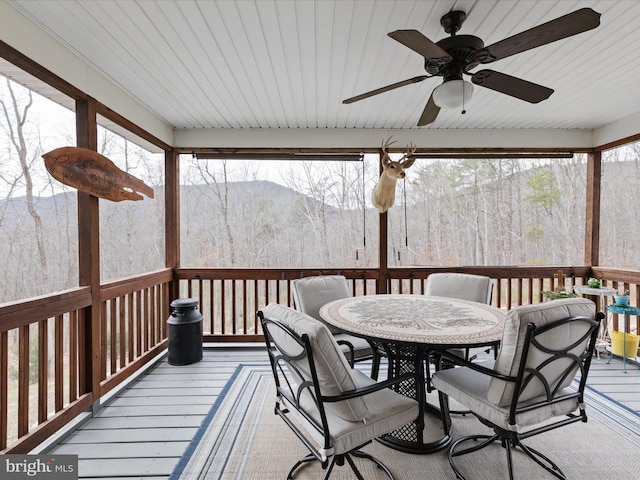 wooden terrace featuring ceiling fan and a mountain view