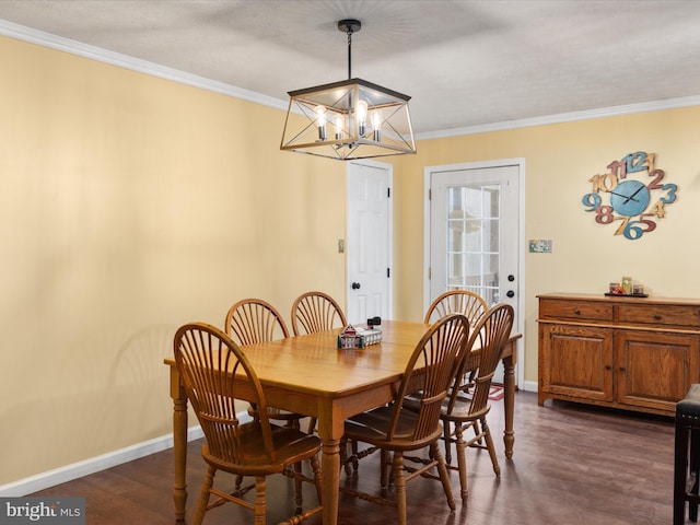 dining space with dark hardwood / wood-style floors, crown molding, and a chandelier