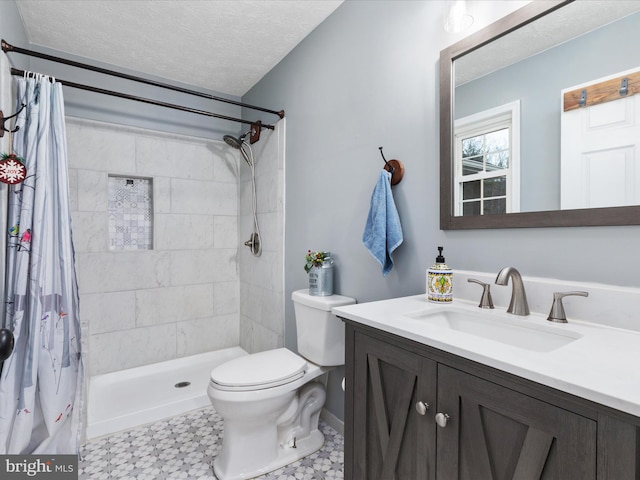 bathroom with a shower with shower curtain, vanity, toilet, and a textured ceiling