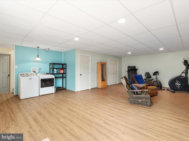 sitting room featuring separate washer and dryer, a paneled ceiling, and light wood-type flooring