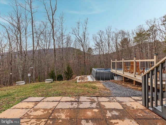 view of patio / terrace featuring a pool side deck with mountain view