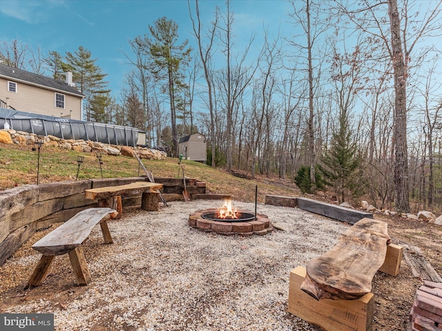 view of patio / terrace featuring a fire pit and a pool