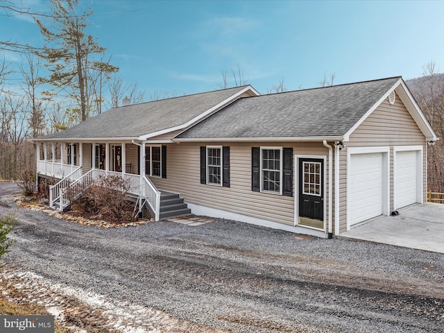 single story home with covered porch and a garage