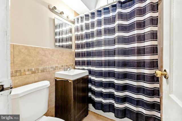 bathroom with tile patterned floors, vanity, toilet, tile walls, and a shower with curtain