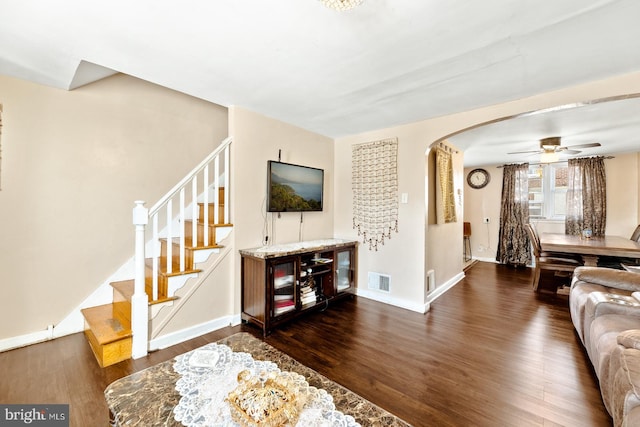 living room featuring dark hardwood / wood-style floors and ceiling fan