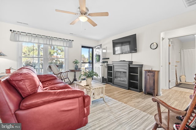 living room with hardwood / wood-style flooring and ceiling fan