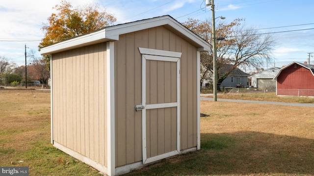 view of outbuilding featuring a lawn