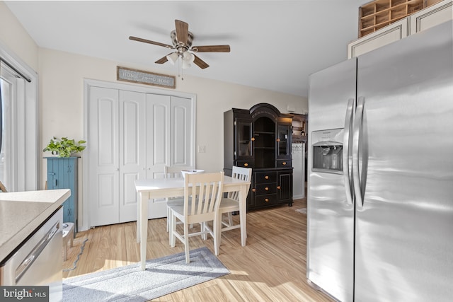 dining space featuring ceiling fan and light wood-type flooring