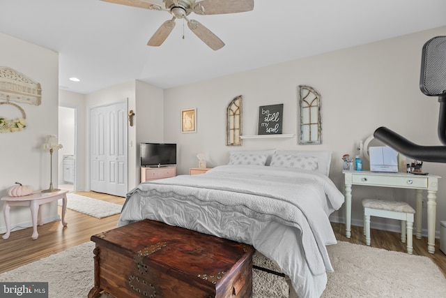 bedroom with a closet, ceiling fan, and light hardwood / wood-style flooring