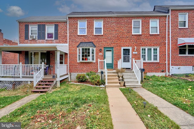 view of property with cooling unit, a porch, and a front yard