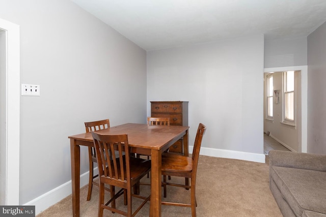 dining space with light colored carpet