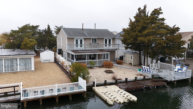 rear view of house with a deck with water view