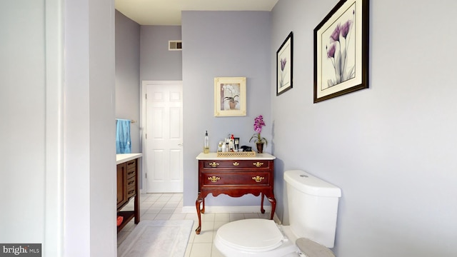 bathroom with tile patterned floors, vanity, and toilet