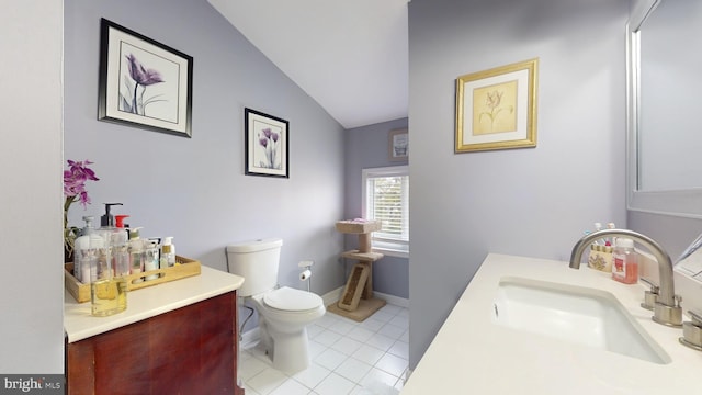 bathroom featuring tile patterned floors, vanity, toilet, and lofted ceiling