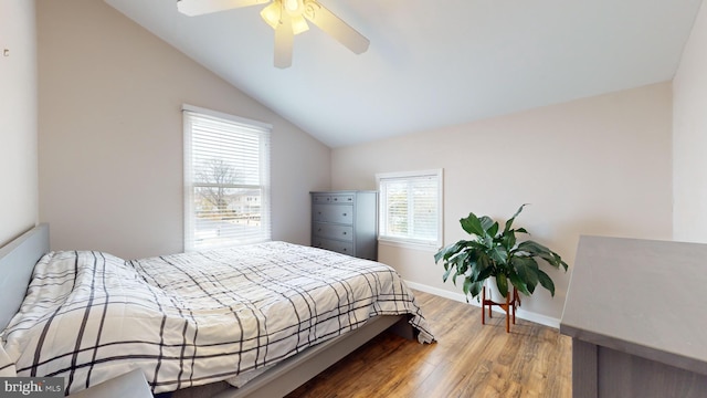 bedroom featuring ceiling fan, hardwood / wood-style floors, and vaulted ceiling