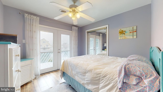 bedroom featuring french doors, light wood-type flooring, access to outside, ceiling fan, and a closet