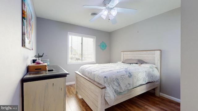 bedroom with ceiling fan and hardwood / wood-style flooring