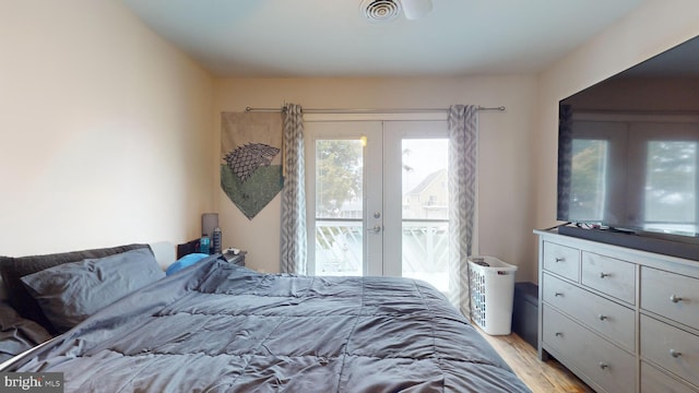 bedroom with access to exterior, french doors, and light hardwood / wood-style flooring