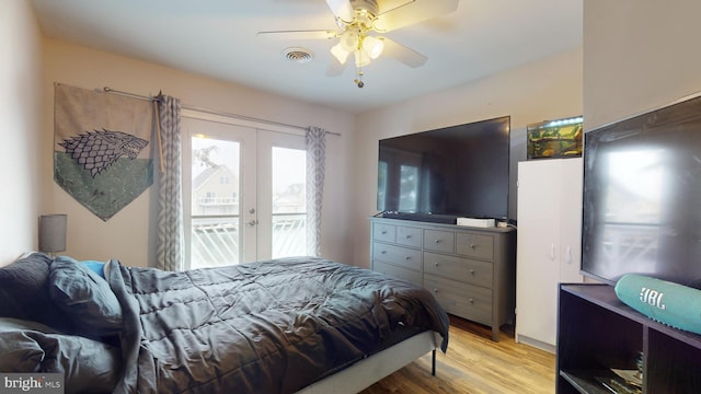 bedroom featuring ceiling fan, light hardwood / wood-style flooring, access to outside, and french doors