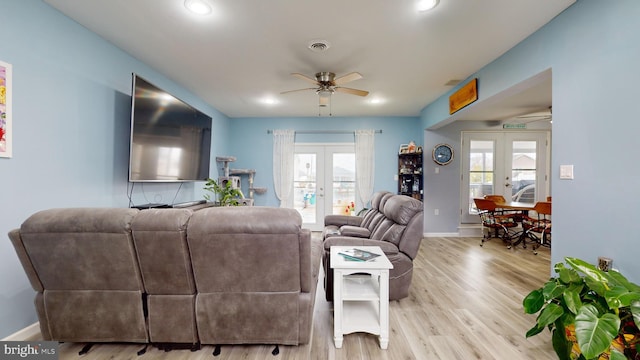 living room featuring french doors, light wood-type flooring, and a wealth of natural light