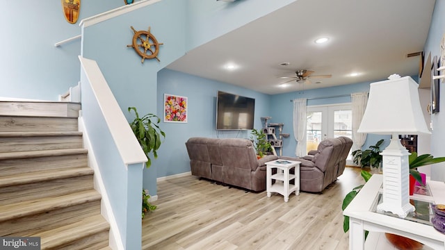 living room with ceiling fan, light wood-type flooring, and french doors