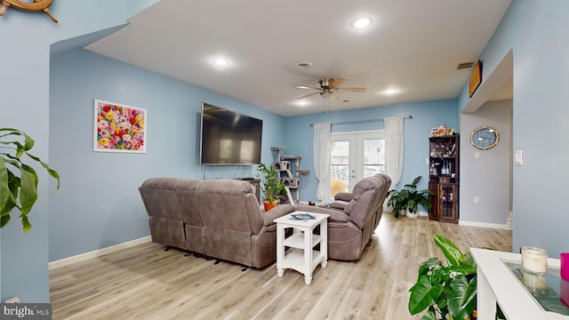 living room featuring ceiling fan, french doors, and light hardwood / wood-style floors