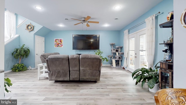 living room with ceiling fan, light hardwood / wood-style floors, and french doors