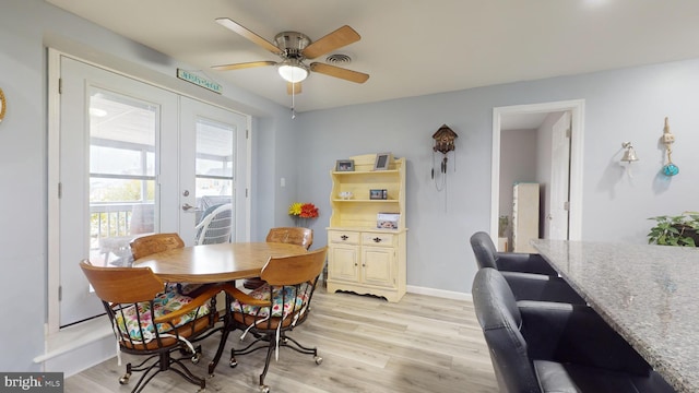 dining room with french doors, light wood-type flooring, and ceiling fan