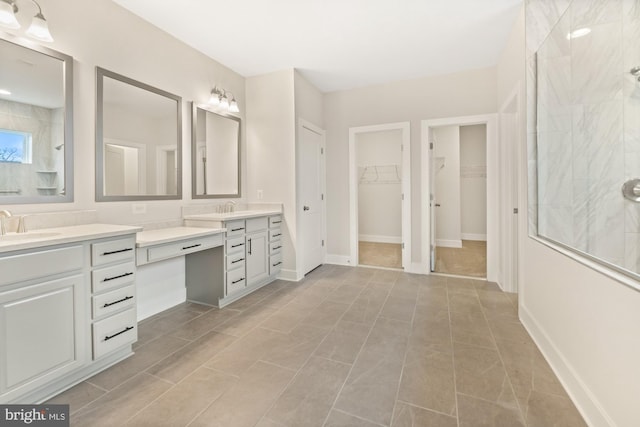 11310 Ingels Ct, Issue, MD 20645 - bathroom featuring tiled shower, vanity, a spacious closet, and baseboards