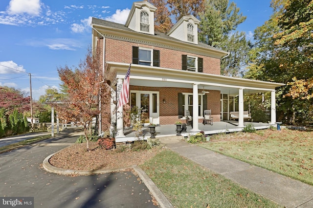 view of front of property with covered porch and brick siding