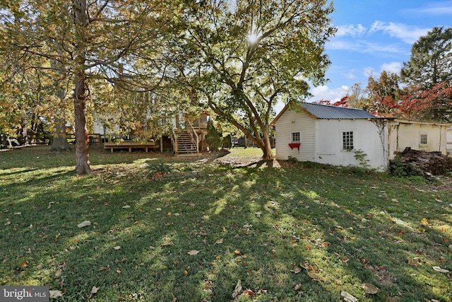 view of yard with an outdoor structure and stairs