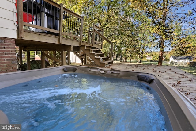 view of pool featuring stairs, a wooden deck, and a hot tub