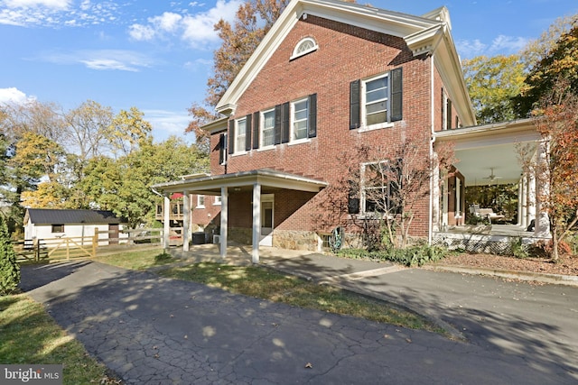 view of front facade featuring covered porch and brick siding