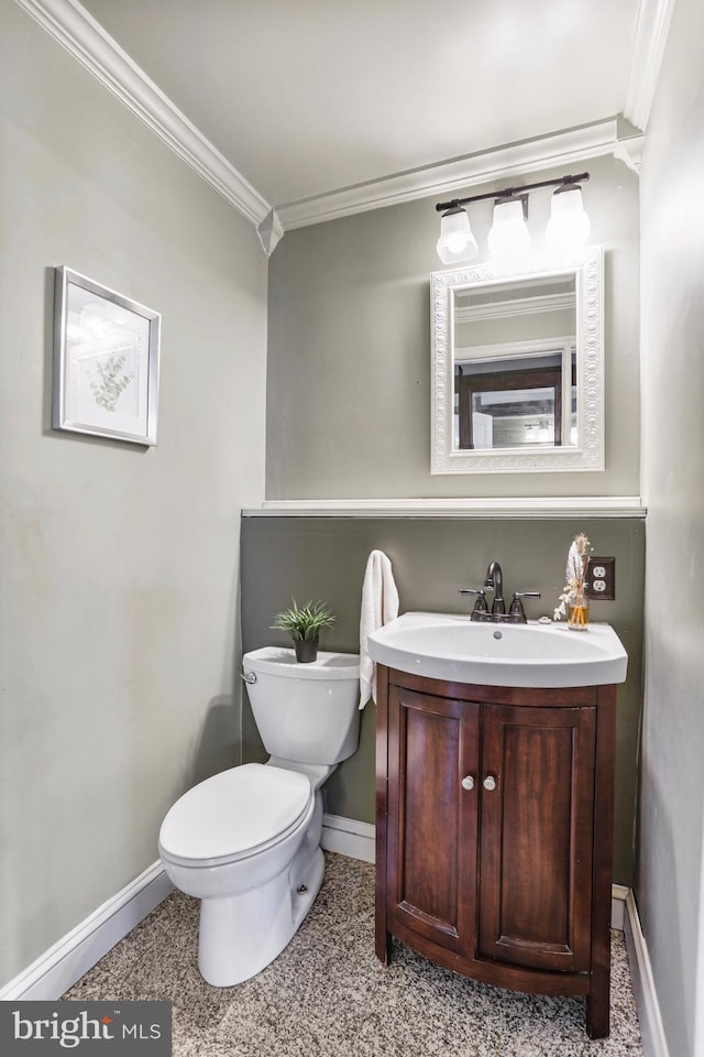 bathroom featuring ornamental molding, vanity, toilet, and baseboards