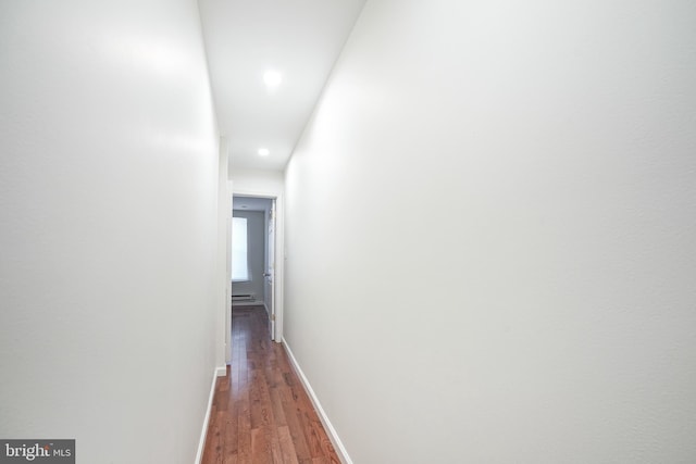 hallway featuring dark hardwood / wood-style flooring and a baseboard radiator