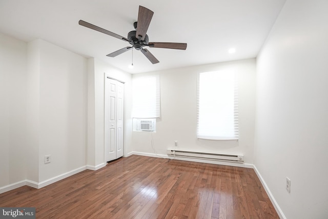 unfurnished room featuring baseboard heating, ceiling fan, and hardwood / wood-style floors