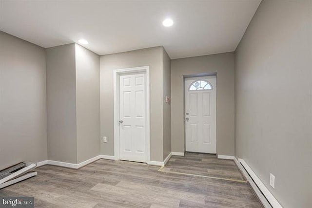 entrance foyer with light wood-type flooring and baseboard heating