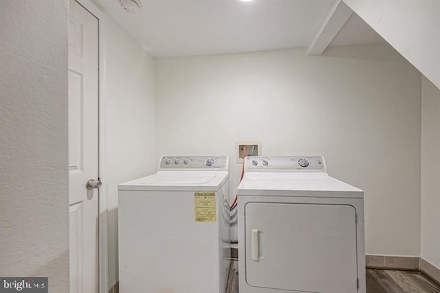 laundry room featuring wood-type flooring and separate washer and dryer