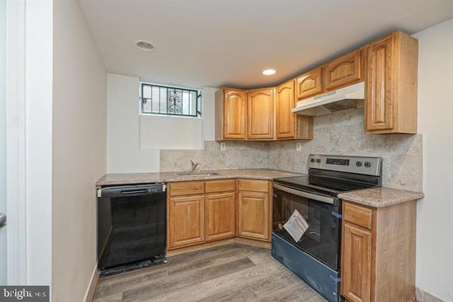 kitchen with sink, light hardwood / wood-style floors, tasteful backsplash, and black appliances