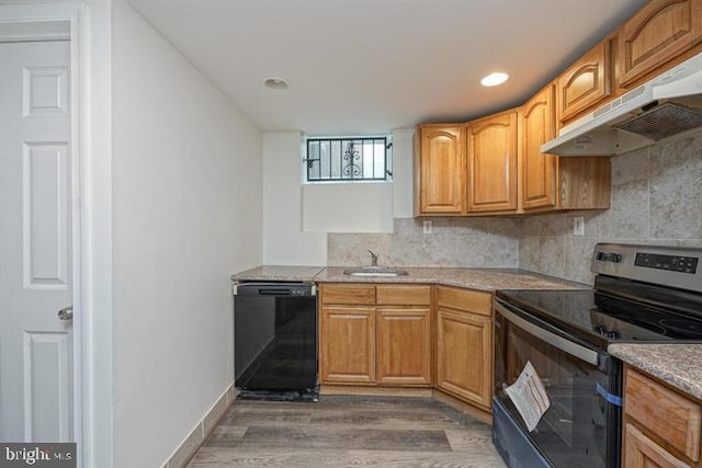 kitchen with dark hardwood / wood-style flooring, backsplash, extractor fan, sink, and black appliances